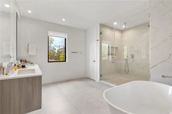 a bathroom with a bathtub and shower