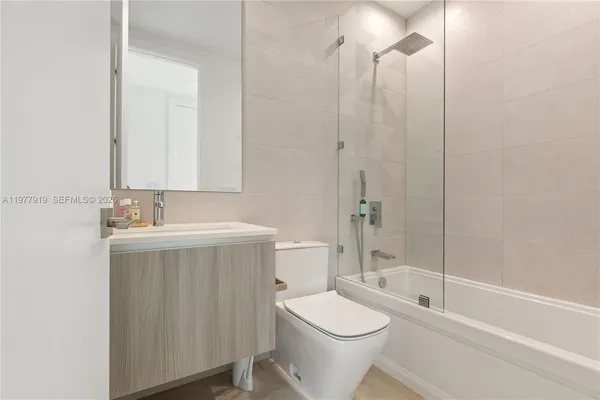 a bathroom with a toilet a sink and shower