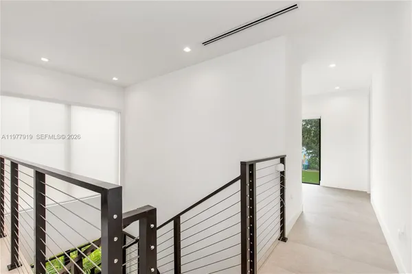 a view of an empty room with floor to ceiling window and an outdoor view