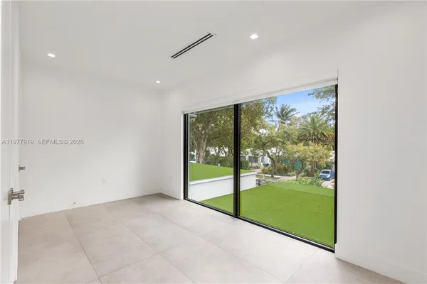 a view of hallway with window and a ceiling fan