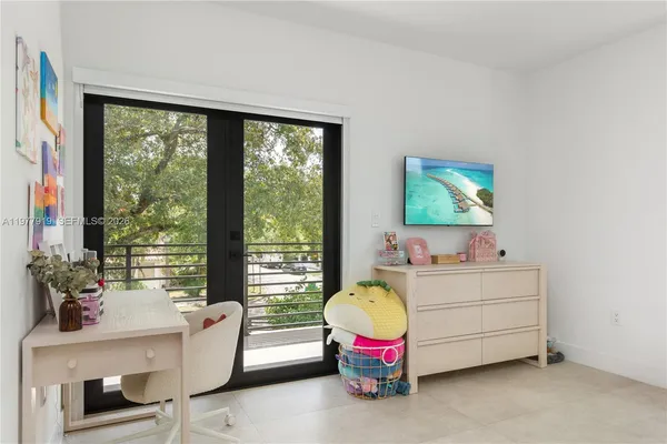 a bedroom with a bed and a desk