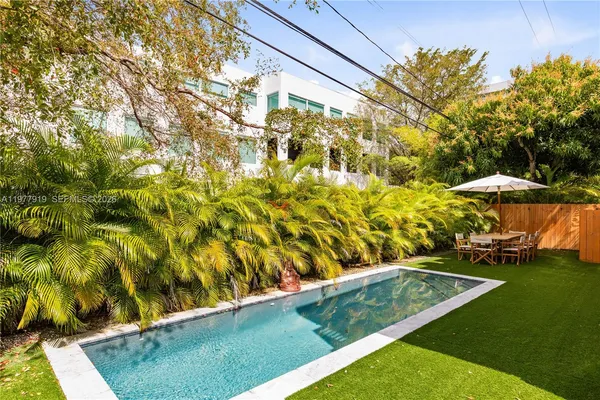 a kitchen with a sink and a stove with wooden floor