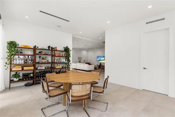 a dining room with a table and chairs