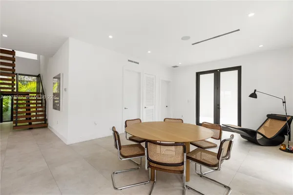 a view of a dining room with furniture and a window