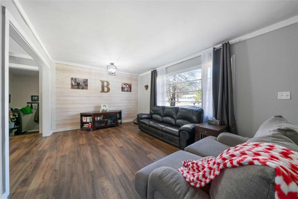 6 Nottingham Way Northeast Rome, GA 30161 - Photo 3 of 16 a bedroom with furniture and a wooden floor
