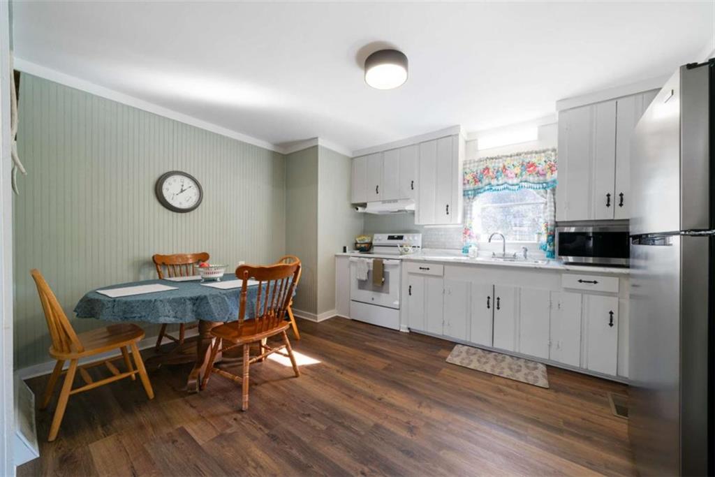6 Nottingham Way Northeast Rome, GA 30161 - Photo 7 of 16 a kitchen with a table chairs refrigerator and cabinets