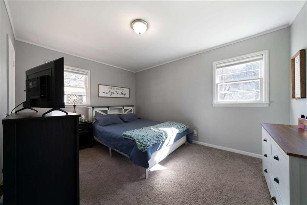 6 Nottingham Way Northeast Rome, GA 30161 - Photo 10 of 16 a bedroom with a bed and a tv on dresser