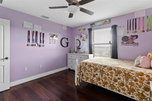 a bedroom with a bed and a wooden floor