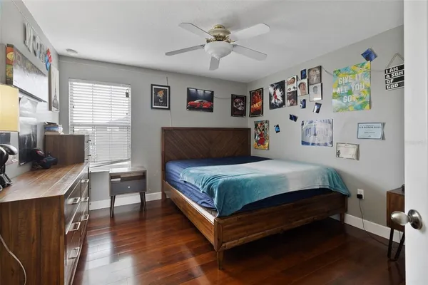 a bedroom with bed and paintings on the wall