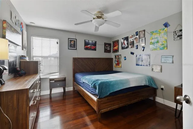 a bedroom with bed and paintings on the wall