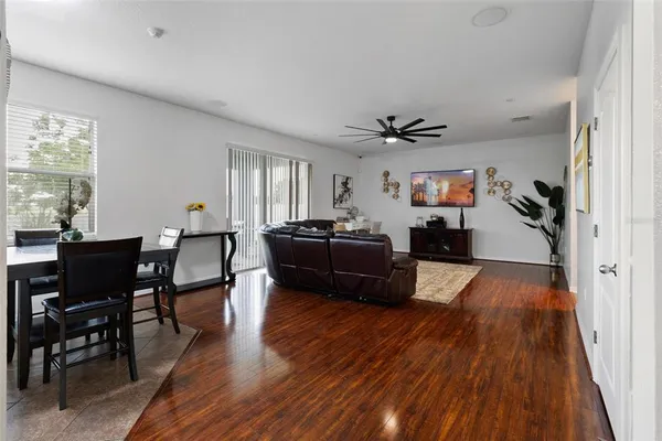 a living room with furniture and wooden floor