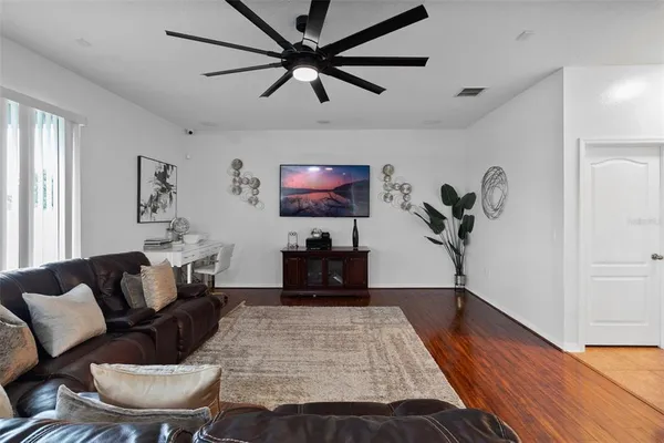 a living room with furniture and kitchen view