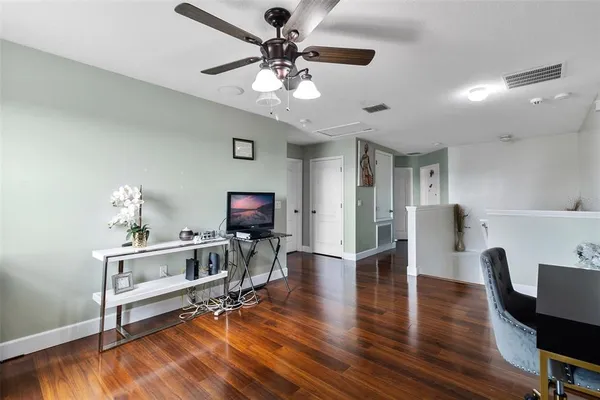 a spacious bedroom with a bed and a flat screen tv