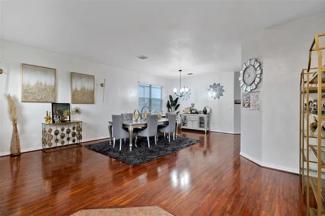 a view of a dining room with furniture and wooden floor