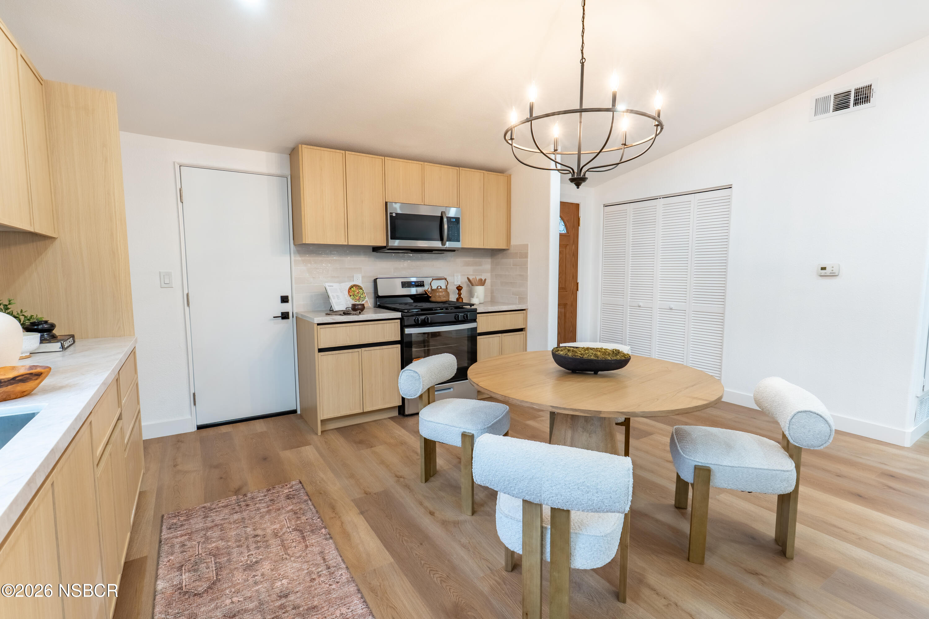 3851 Via Lato Lompoc, CA 93436 - Photo 5 of 19 a kitchen with a table chairs sink and cabinets