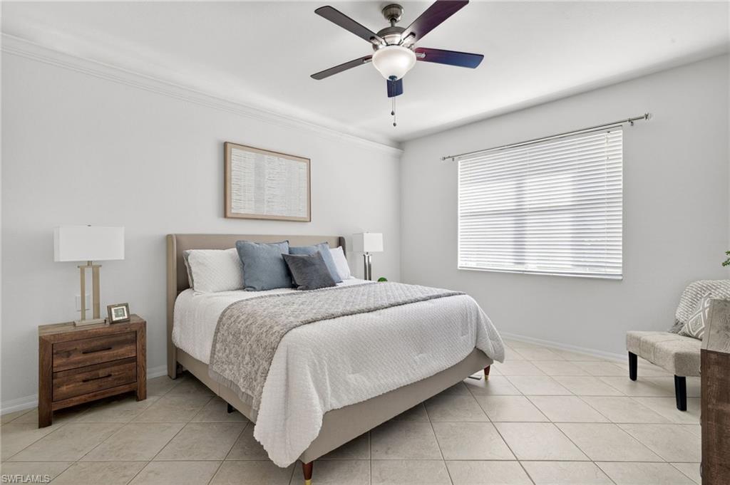 14088 Mirror Court Naples, FL 34114 - Photo 14 of 31 Primary Bedroom with ceiling fan, light tile patterned floors, and crown molding with lighting