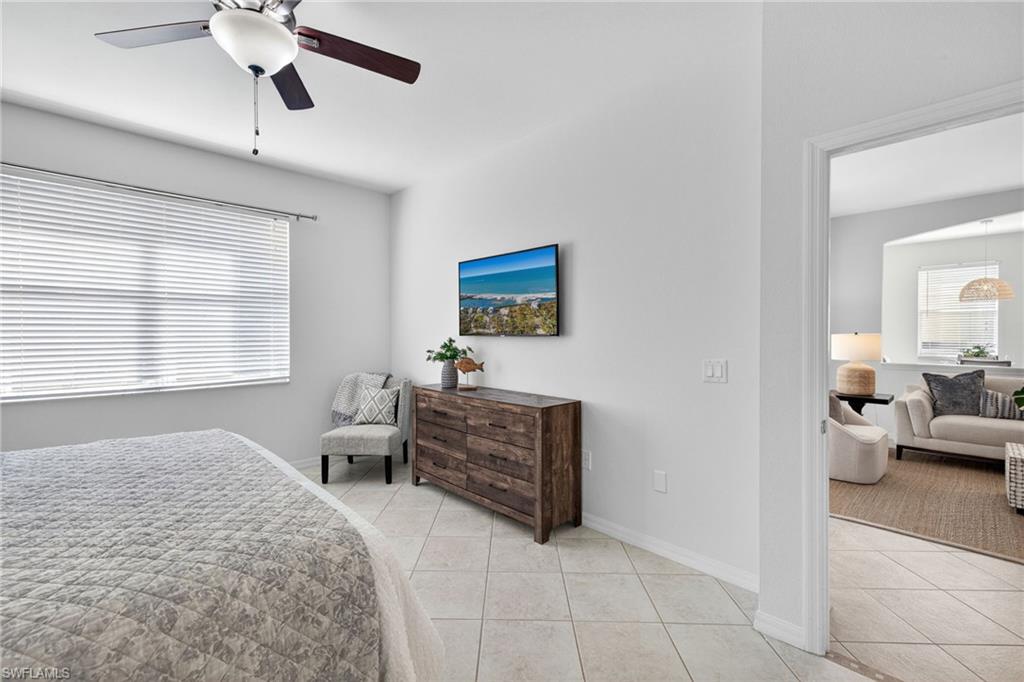 14088 Mirror Court Naples, FL 34114 - Photo 16 of 31 Bedroom featuring light tile patterned floors and a ceiling fan