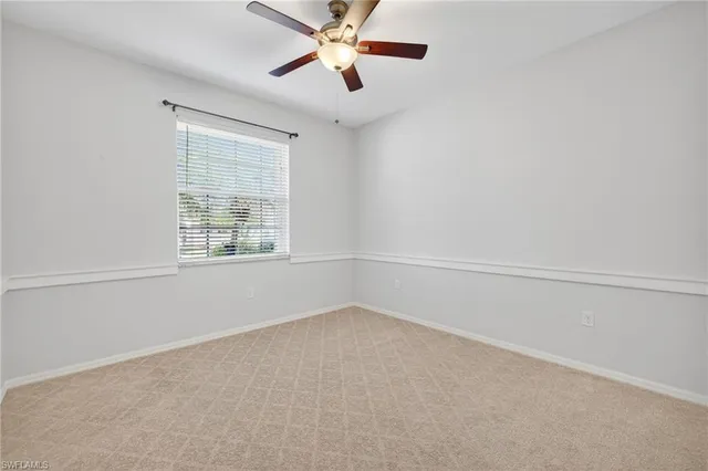 an empty room with a ceiling fan and a ceiling fan