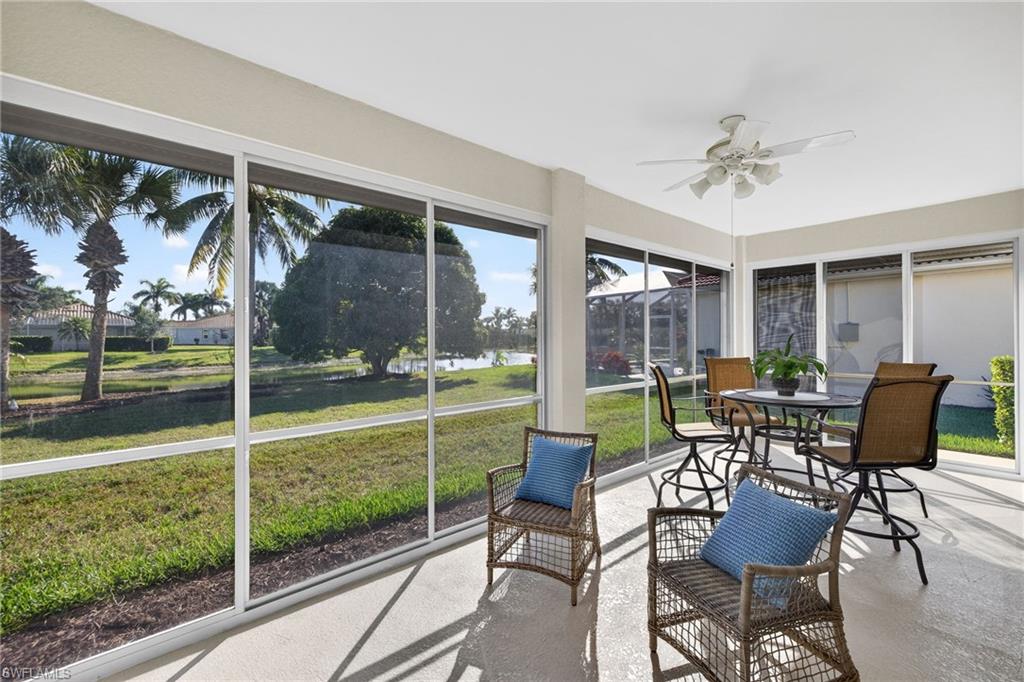 14088 Mirror Court Naples, FL 34114 - Photo 27 of 31 Enclosed Lanai featuring a water view, ceiling fans, and outdoor dining space