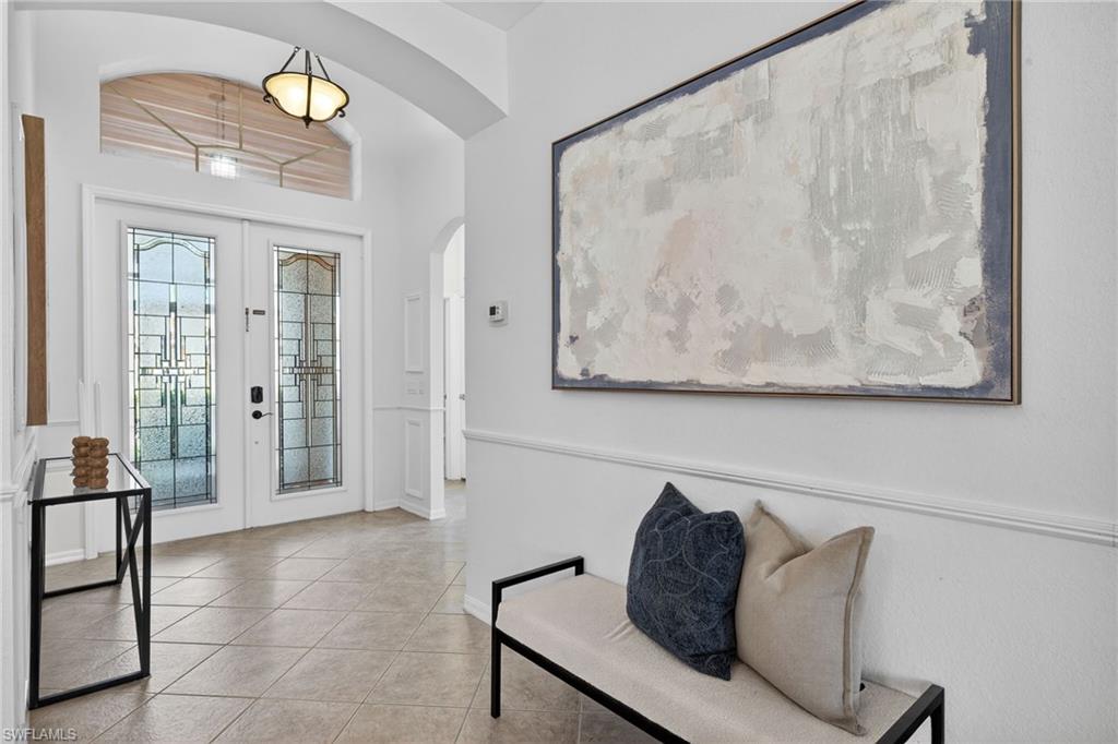 14088 Mirror Court Naples, FL 34114 - Photo 4 of 31 Tiled foyer entrance with french doors and arched walkways