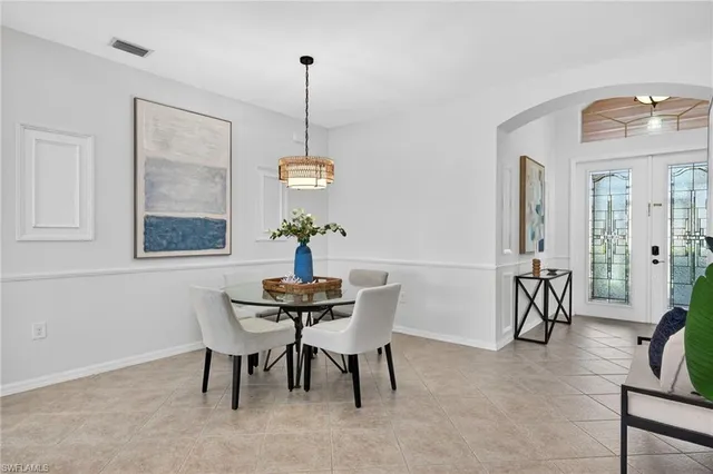 a dining room with furniture and window