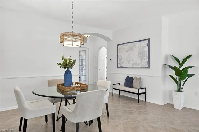 a dining room with furniture and a window