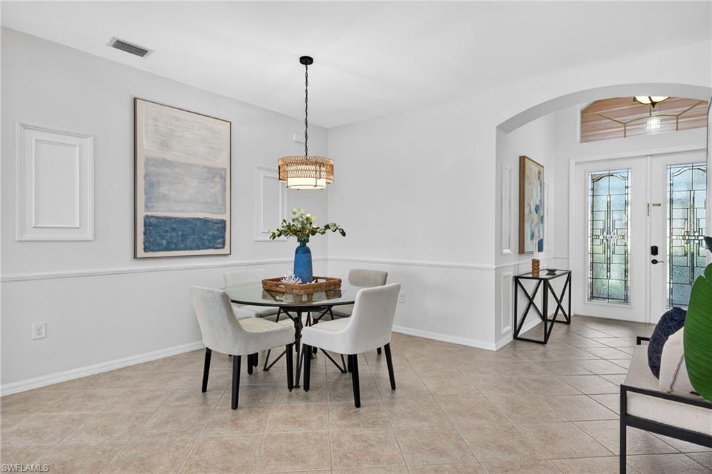 14088 Mirror Court Naples, FL 34114 - Photo 8 of 31 Dining room with arched walkways, french doors, and light tile patterned flooring