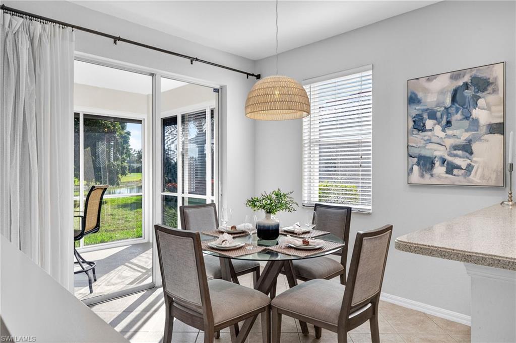 14088 Mirror Court Naples, FL 34114 - Photo 10 of 31 Kitchen Dining space featuring plenty of natural light, a water view, and light tile patterned floors