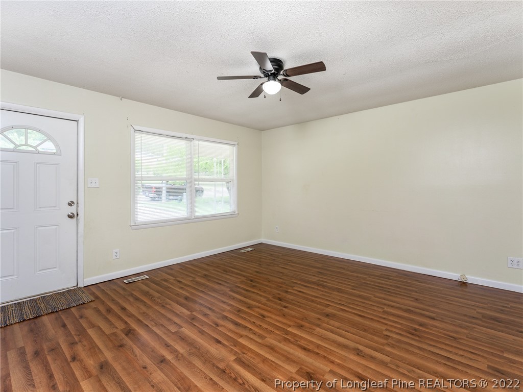 4475 Ruby Road Fayetteville, NC 28311 - Photo 4 of 19 a view of empty room with wooden floor and fan