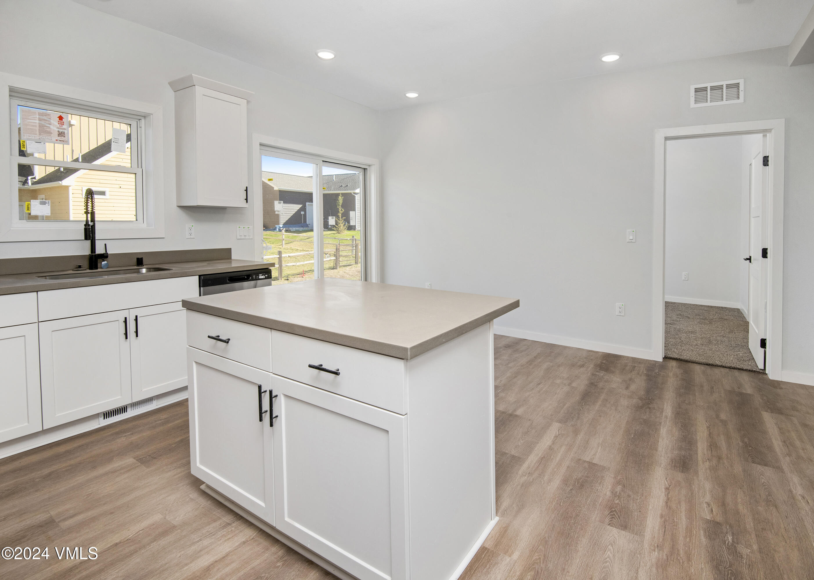 590 Blackhawk Road Gypsum, CO 81637 - Photo 15 of 42 a kitchen with granite countertop white cabinets and white appliances