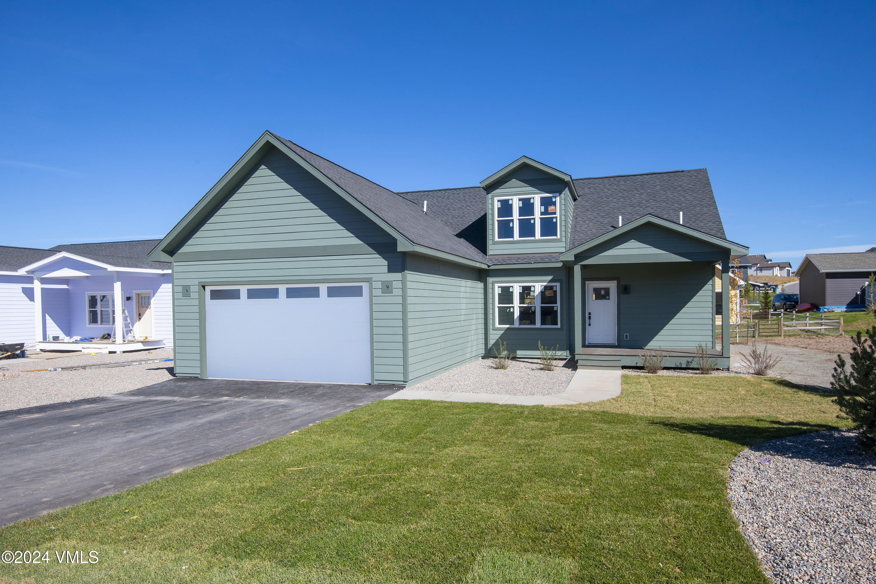 590 Blackhawk Road Gypsum, CO 81637 - Photo 2 of 42 a front view of a house with a yard and garage