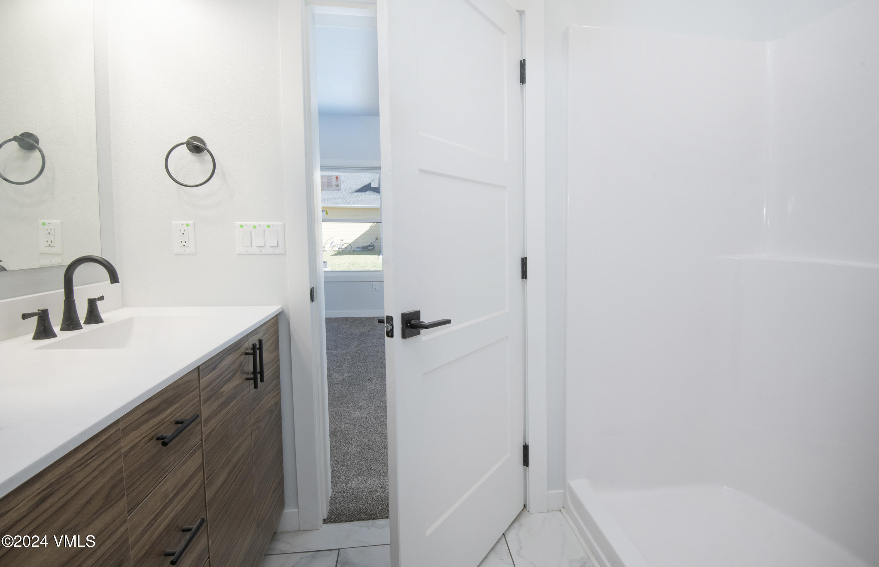 590 Blackhawk Road Gypsum, CO 81637 - Photo 25 of 42 a bathroom with a sink and mirror with shower