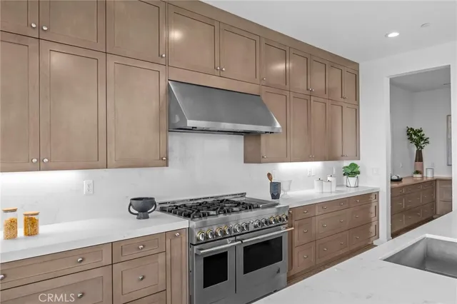 a kitchen with granite countertop cabinets and steel stainless steel appliances