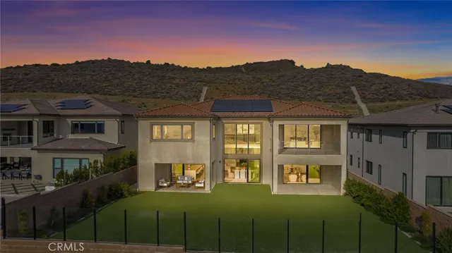 a view of a big house with a big yard and large trees