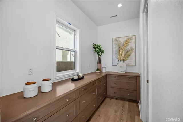 a spacious bathroom with a granite countertop sink mirror and bathtub