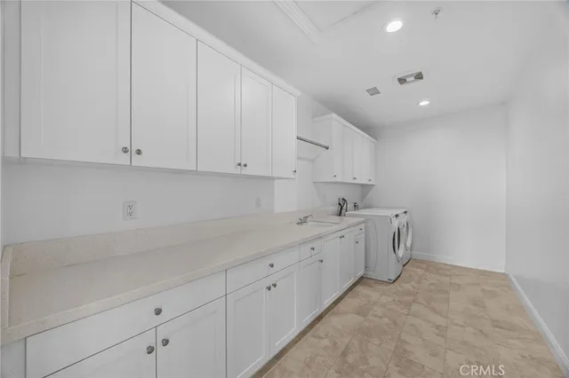 a room with white cabinets and sink