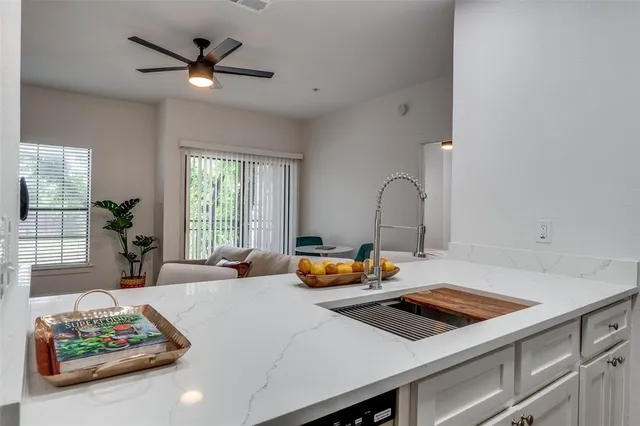 a kitchen with a sink a stove and cabinets