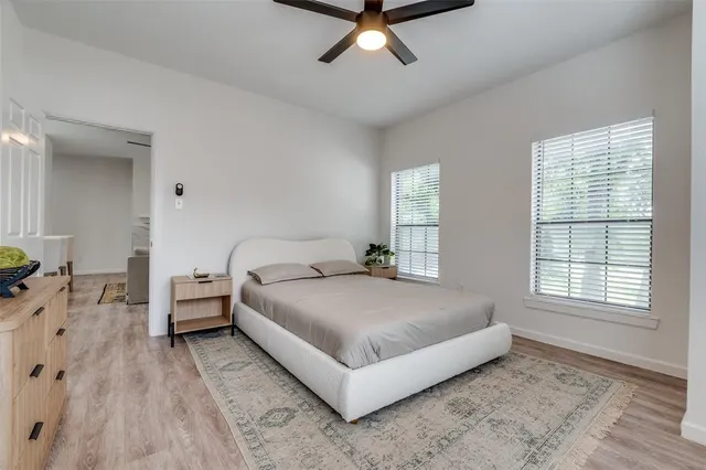 a bedroom with a bed and ceiling fan