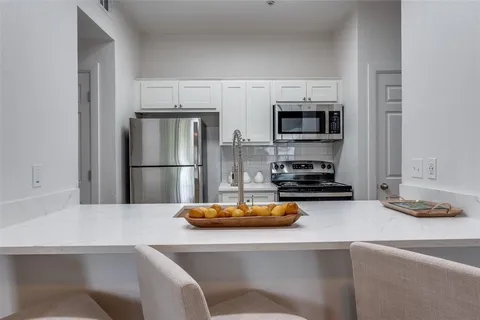 a room with a table chairs and wooden floor