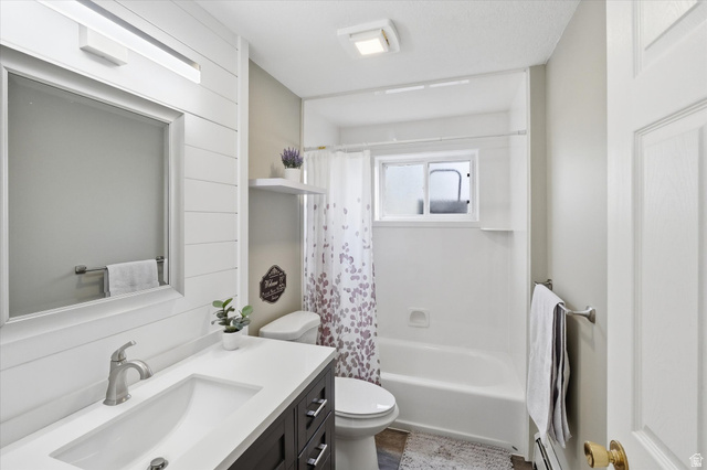 45 West 100 South Mendon, UT 84325 - Photo 35 of 64 Full bathroom with vanity, shower / bath combo, and a baseboard heating unit