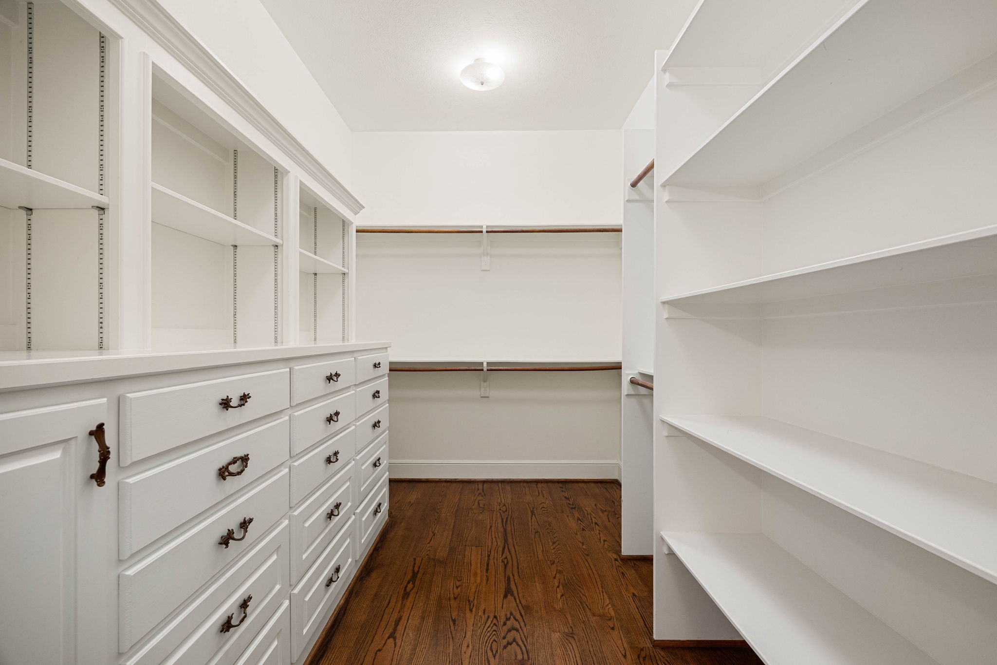 6039 Franz Road Katy, TX 77493 - Photo 25 of 49 Extensive built-in drawers, shelving, and double-hung rods provide abundant, organized storage in the primary suite's expansive walk-in closet.
