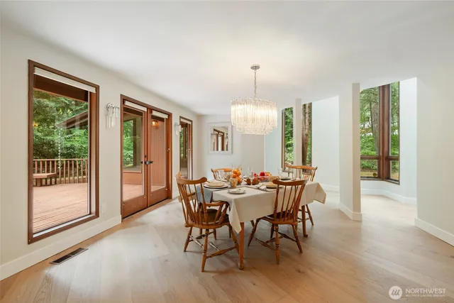 a dining room with furniture a chandelier and a rug