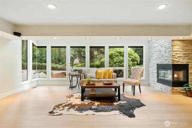 a living room with furniture large window and a fireplace