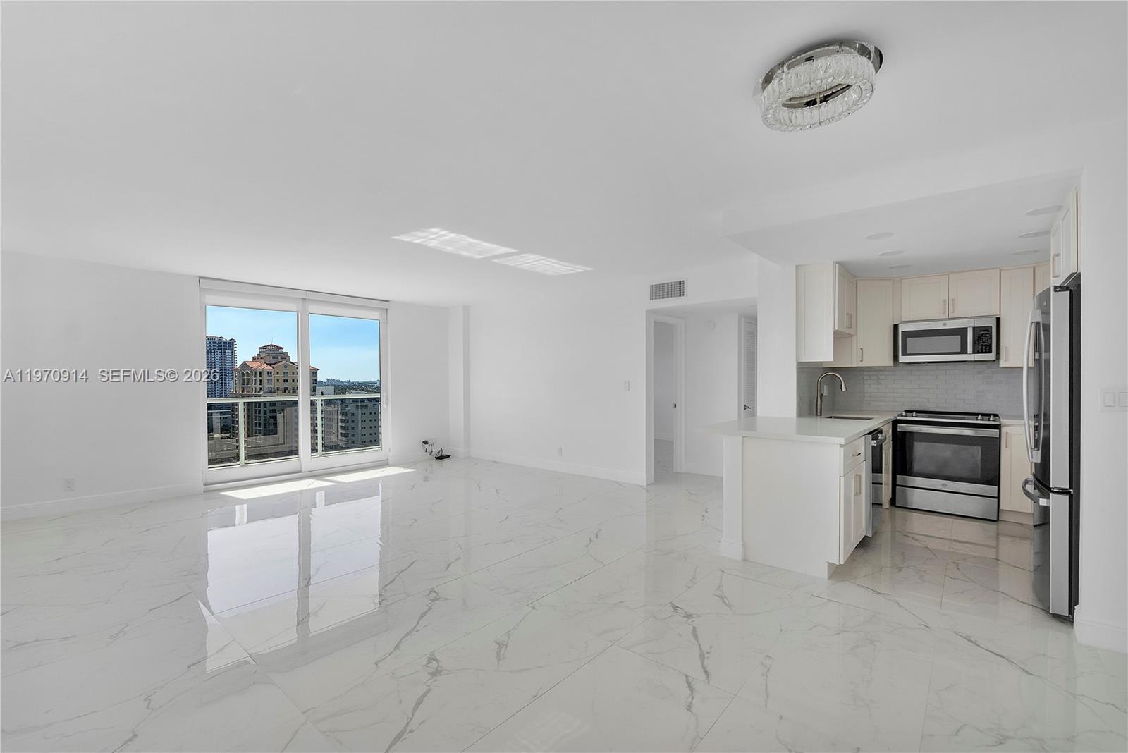 336 North Birch Road, Unit PH Fort Lauderdale, FL 33304 - Photo 6 of 68 a view of a kitchen with furniture and an empty space