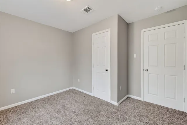 a view of an empty room and entryway