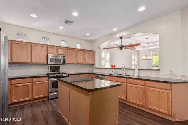a kitchen with granite countertop a sink and cabinets