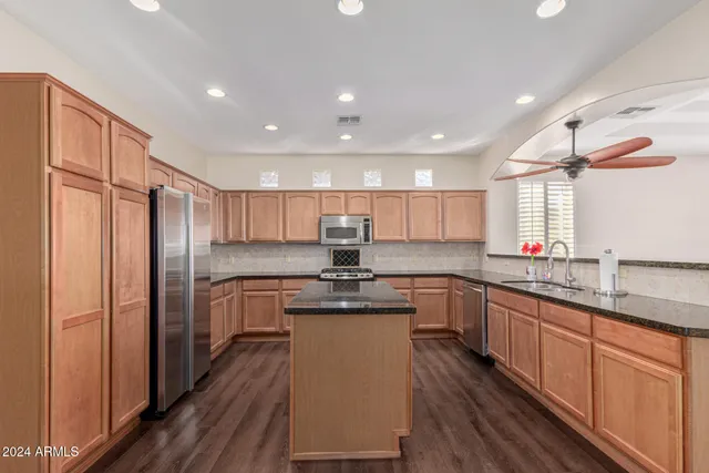 a view of a livingroom with a ceiling fan and window