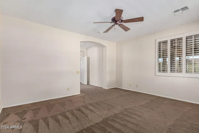 a spacious bathroom with a double vanity sink a large mirror and a shower