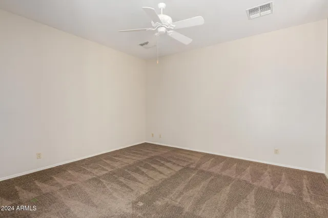 a front view of a house with a tree