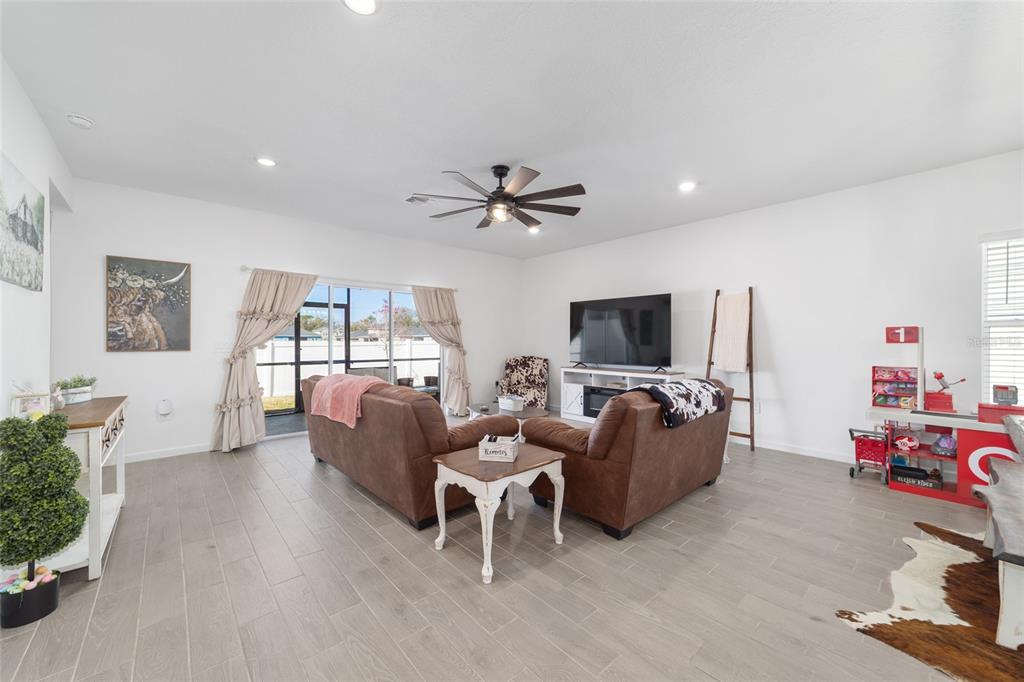 4012 Northeast 33rd Avenue Ocala, FL 34479 - Photo 11 of 77 a living room with furniture and a flat screen tv